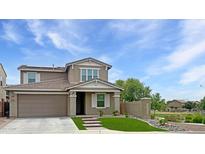 Charming two-story home with a well-manicured front yard and attached two-car garage, situated on a sunny lot at 12227 W Prickly Pear Trl, Peoria, AZ 85383