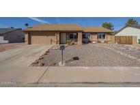 Charming single-story home with low-maintenance desert landscaping and a two-car garage at 1226 N Nevada Way, Mesa, AZ 85203