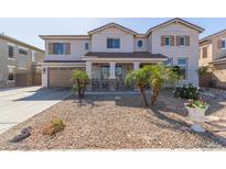 Beautiful two-story home with desert landscaping, covered porch, and shutters at 14369 W Caribbean Ln, Surprise, AZ 85379