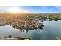 Stunning aerial view of waterfront homes with lush landscaping reflecting in the lake at sunset at 1700 E Lakeside Dr # 16, Gilbert, AZ 85234