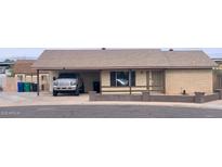 Charming single story home with covered parking and desert landscaping at 1858 N Hibbert Cir, Mesa, AZ 85201
