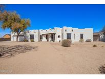 Stunning single-story home featuring a custom adobe design and desert landscaping at 22236 E Nacoma --, Queen Creek, AZ 85142