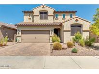 Charming two-story home featuring a tile roof, brick driveway, and well-maintained landscaping at 3668 E Ficus Way, Gilbert, AZ 85298