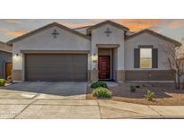 Charming single-story home with a two-car garage and a well-maintained desert landscape at 38145 W Amalfi Ave, Maricopa, AZ 85138