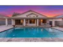 Inviting backyard pool with water feature, covered patio, and beautiful sunset views at 445 W Gary Ave, Gilbert, AZ 85233