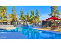 Community swimming pool featuring covered seating areas and beautiful clear water at 5136 E Evergreen St # 1075, Mesa, AZ 85205