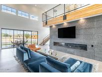 Bright, open living room with a stone accent wall, fireplace and clerestory windows at 8510 S 9Th Dr # 20, Phoenix, AZ 85041