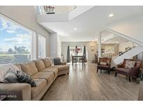 Open-concept living room, with wood floors and lots of seating at 8813 S 51St St # 3, Phoenix, AZ 85044