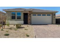 Charming single-story home featuring brick accents, a two-car garage and desert landscaping at 11744 S 173Rd Ln, Goodyear, AZ 85338