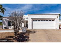 Charming one-story home with a well-maintained front yard and a two-car garage at 1202 E Winged Foot Rd, Phoenix, AZ 85022