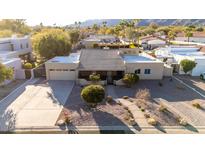 Inviting home featuring a low-maintenance desert landscape, tile roof, and attached garage at 12222 S Appaloosa Dr, Phoenix, AZ 85044