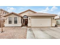 Charming home featuring a well-maintained front yard and a two-car garage at 1565 E 10Th St, Casa Grande, AZ 85122