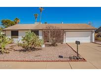 Charming single-story home featuring desert landscaping and an attached two-car garage at 15811 N 23Rd St, Phoenix, AZ 85022