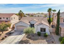 Charming single story home with desert landscaping, a two car garage, and a tile roof at 17839 W Maui Ln, Surprise, AZ 85388