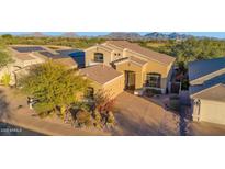 Stunning view of this desert home with professional landscaping, paver driveway and mountain views at 22211 N 51St St, Phoenix, AZ 85054