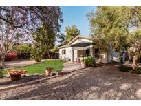 Charming home with a well-manicured lawn, covered patio, and desert landscaping at 22288 S 214Th S St, Queen Creek, AZ 85142