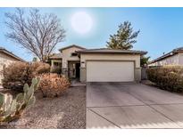 Charming single-story home featuring desert landscaping and an attached two-car garage at 22288 S 214Th S St, Queen Creek, AZ 85142