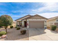 Charming single-story home featuring a well-maintained yard and a two-car garage at 227 W Lantern Way, San Tan Valley, AZ 85143