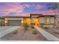 Charming single-story home with desert landscaping, a two-car garage and a welcoming front porch at 23004 E Desert Spoon Dr, Queen Creek, AZ 85142