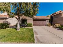 Home featuring desert landscaping, a tile roof, and an attached two-car garage at 3238 E Ashurst Dr, Phoenix, AZ 85048