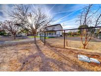 Spacious front yard featuring a traditional two-story home with a charming front porch at 3929 E Flintlock Dr, Queen Creek, AZ 85142