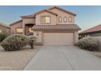 Inviting tan stucco home featuring a tile roof, desert landscaping, and an attached two-car garage at 4625 E Thorn Tree Dr, Cave Creek, AZ 85331