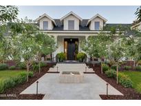 Stunning two-story home with a water feature, professional landscaping, and inviting front entrance at 5144 E Calle Del Medio --, Phoenix, AZ 85018