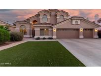 Charming two-story home featuring a tile roof, stucco exterior, well-manicured lawn, and a two-car garage at 5545 E Helena Dr, Scottsdale, AZ 85254