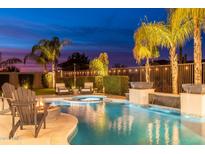 Backyard oasis with a sparkling pool, spa, and fire pit, perfect for entertaining at 5904 E Calle De Las Estrellas Rd, Cave Creek, AZ 85331