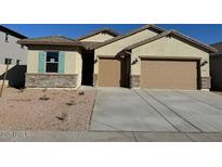 Charming single-story home features a stone facade, two-car garage and neutral-colored stucco at 7050 E Brushy Bill Rd, San Tan Valley, AZ 85143