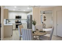 Bright kitchen with stainless steel appliances and casual dining area with modern decor at 10146 W Watkins St, Tolleson, AZ 85353