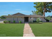 Charming single-story home with well-maintained landscaping and a stone walkway leading to the front door at 1509 W Kiowa Ave, Mesa, AZ 85202