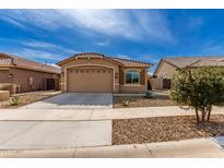 Charming single-story home with a tile roof, desert landscaping and a two car garage at 16593 W Alameda Rd, Surprise, AZ 85387