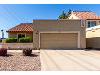 Inviting home featuring a two car garage, a tile roof, and low maintenance desert landscaping at 2848 E Brown Rd # 30, Mesa, AZ 85213