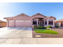 Beautiful single-story home with a three-car garage, desert landscaping, and a charming front entrance at 2854 S Berrywood --, Mesa, AZ 85212