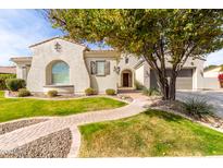 Charming stucco home showcasing mature landscaping, a brick walkway, and a two-car garage at 30488 N 126Th Dr, Peoria, AZ 85383