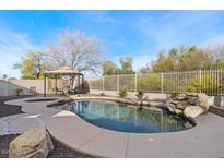 Backyard pool and patio are enhanced by desert landscaping and a decorative gazebo, perfect for outdoor gatherings at 3746 E Vallejo Dr, Gilbert, AZ 85298