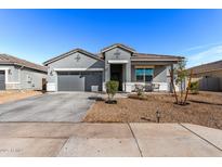 Charming single-story home featuring a well-manicured front yard and a two-car garage at 3923 S 244Th Dr, Buckeye, AZ 85326