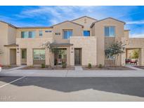 Inviting two-story townhome featuring desert landscaping and a stone facade at 729 E Zesta Ln # 102, Gilbert, AZ 85297