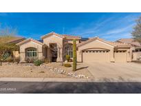 Charming single-story home with a two-car garage, desert landscaping, and a tiled roof at 11596 E La Junta Rd, Scottsdale, AZ 85255