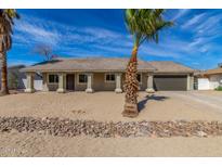 Charming single-story home featuring a desert landscaped yard with a neutral-colored facade and attached garage at 1318 E Mission Grande Ave, Casa Grande, AZ 85122