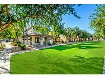 Charming home featuring a well-manicured lawn and a cozy front porch perfect for relaxing outdoors at 1531 S Owl Dr, Gilbert, AZ 85296