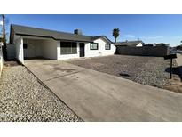 Charming single-story home with white exterior and driveway at 1734 E Wier Ave, Phoenix, AZ 85040