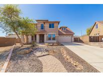 Charming two-story home featuring a manicured front yard with a brick pathway leading to the front door at 18431 W Cinnabar Ave, Waddell, AZ 85355