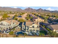 Stunning aerial view of home, showcasing the pool, patio, and mountain views at 19240 N 90Th Pl, Scottsdale, AZ 85255