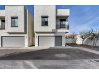 Modern townhome featuring a neutral-colored exterior, garage, and clean architectural lines at 2030 E Michigan Ave # 9, Phoenix, AZ 85022