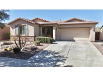 Charming single-story home with well-manicured landscaping and a two-car garage at 24050 N 164Th Ave, Surprise, AZ 85387