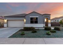 Charming single-story home showcasing a well-maintained front yard with desert landscaping and a two car garage at 30071 W Indianola Ave, Buckeye, AZ 85396