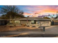 Charming single-story home with a well-maintained landscape, desert-style front yard, and a spacious two-car garage at 3834 E Shaw Butte Dr, Phoenix, AZ 85028