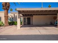 Tan house with a covered carport and desert landscaping for low maintenance at 459 S Boojum Way, Mesa, AZ 85208